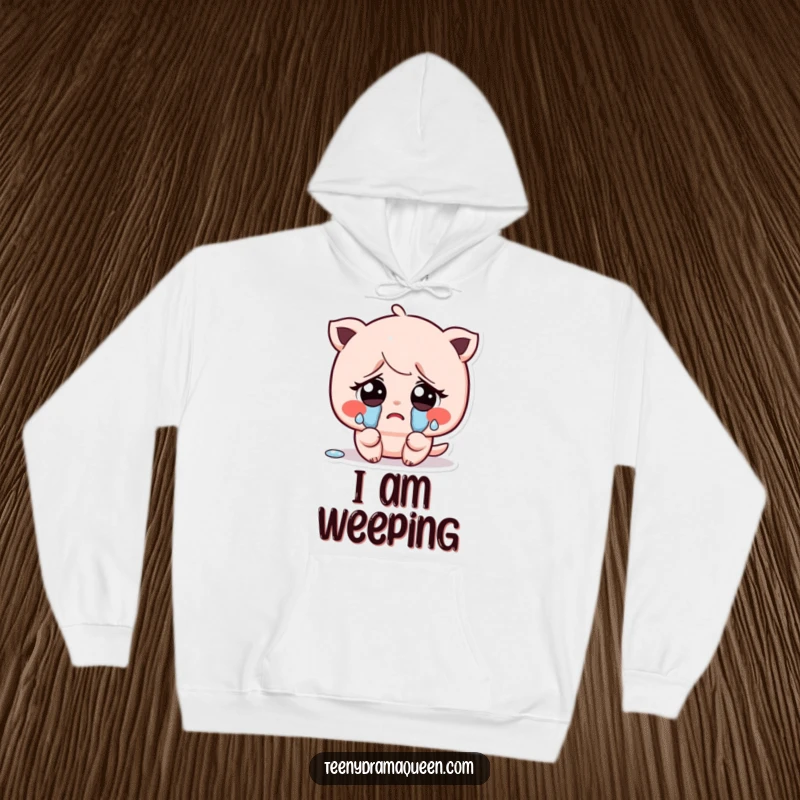 Funny hoodie displaying a kawaii character with large, sad eyes, shedding small, exaggerated tears, evoking a feeling of gentle sadness.